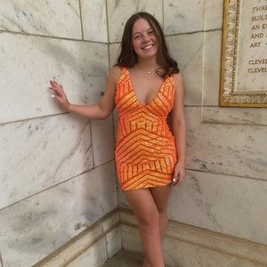I am selling my homecoming dress: size 6, orange and sparkly Jovani dress.